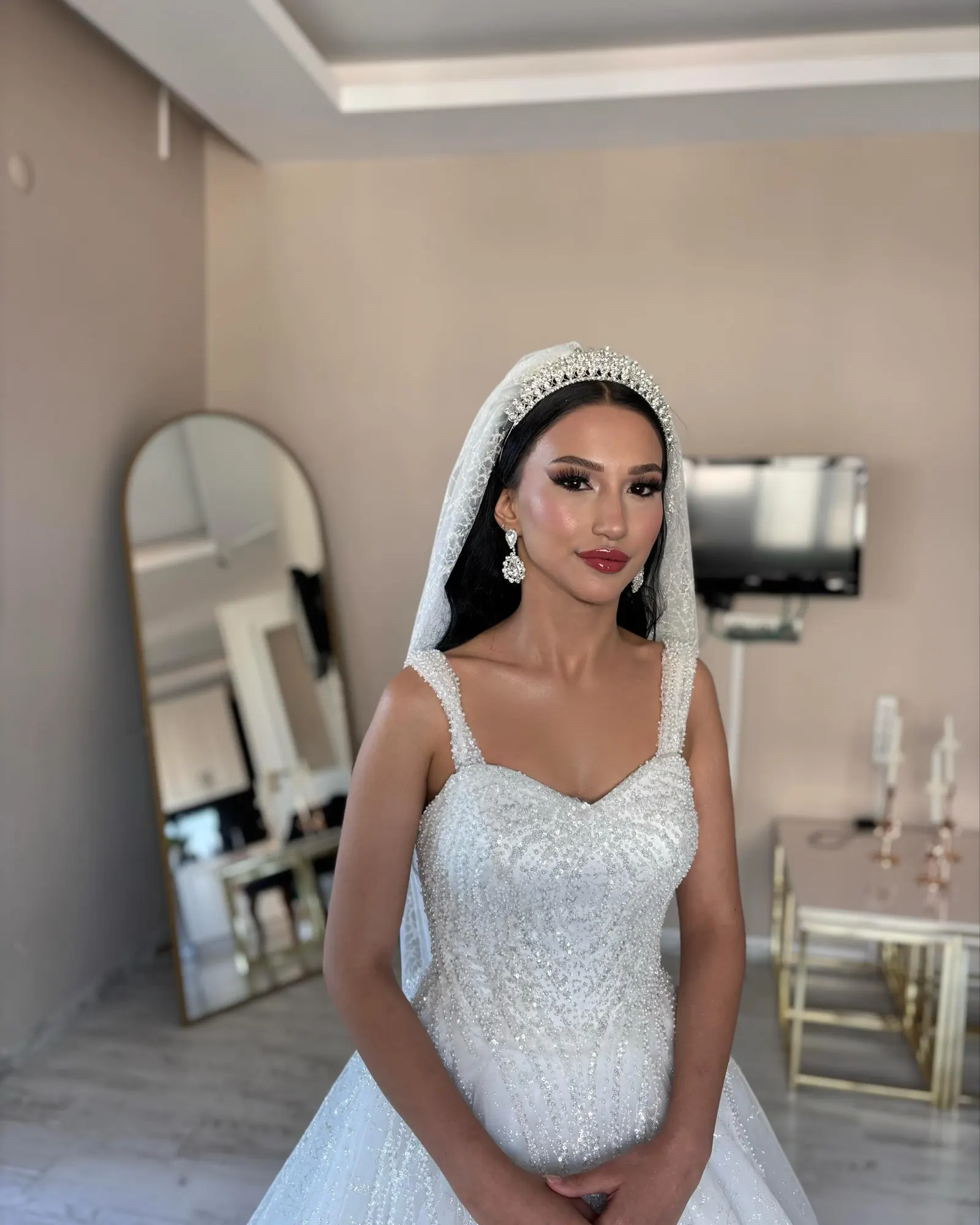 Salonda hazırlanan gelin, arkada kemerli ayna